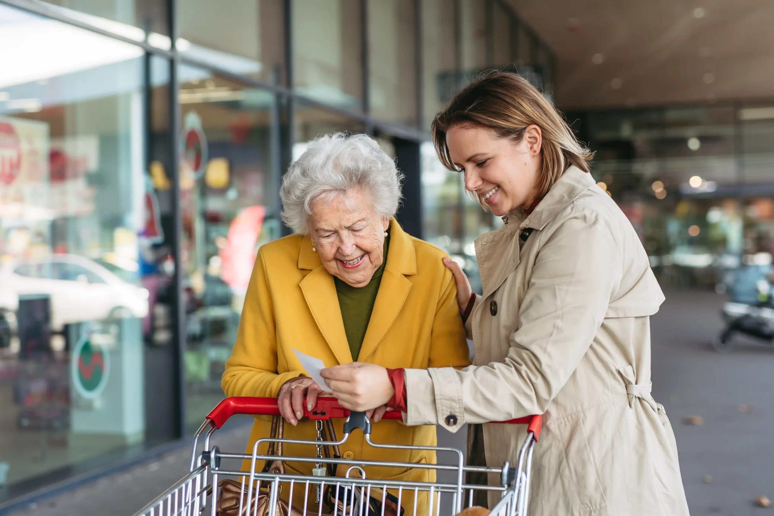 Senior woman and young adult shopping together
